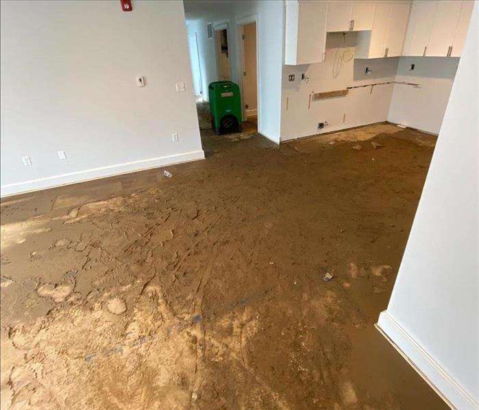 pipe leak in an almost finished apartment left standing water and mud all over the floors