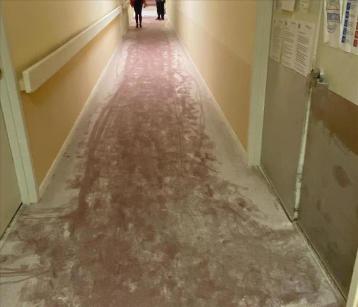 white dust covering carpeted apartment hallway due to fire extinguisher being used