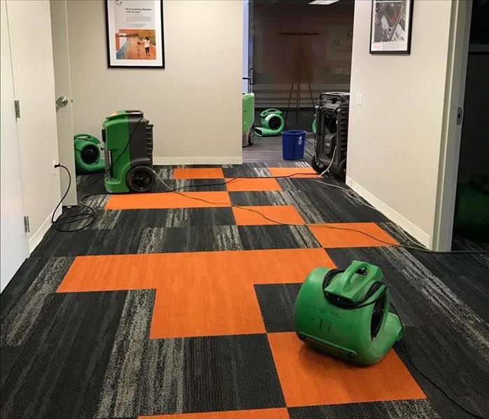 SERVPRO equipment set up on a water damaged carpet in an office